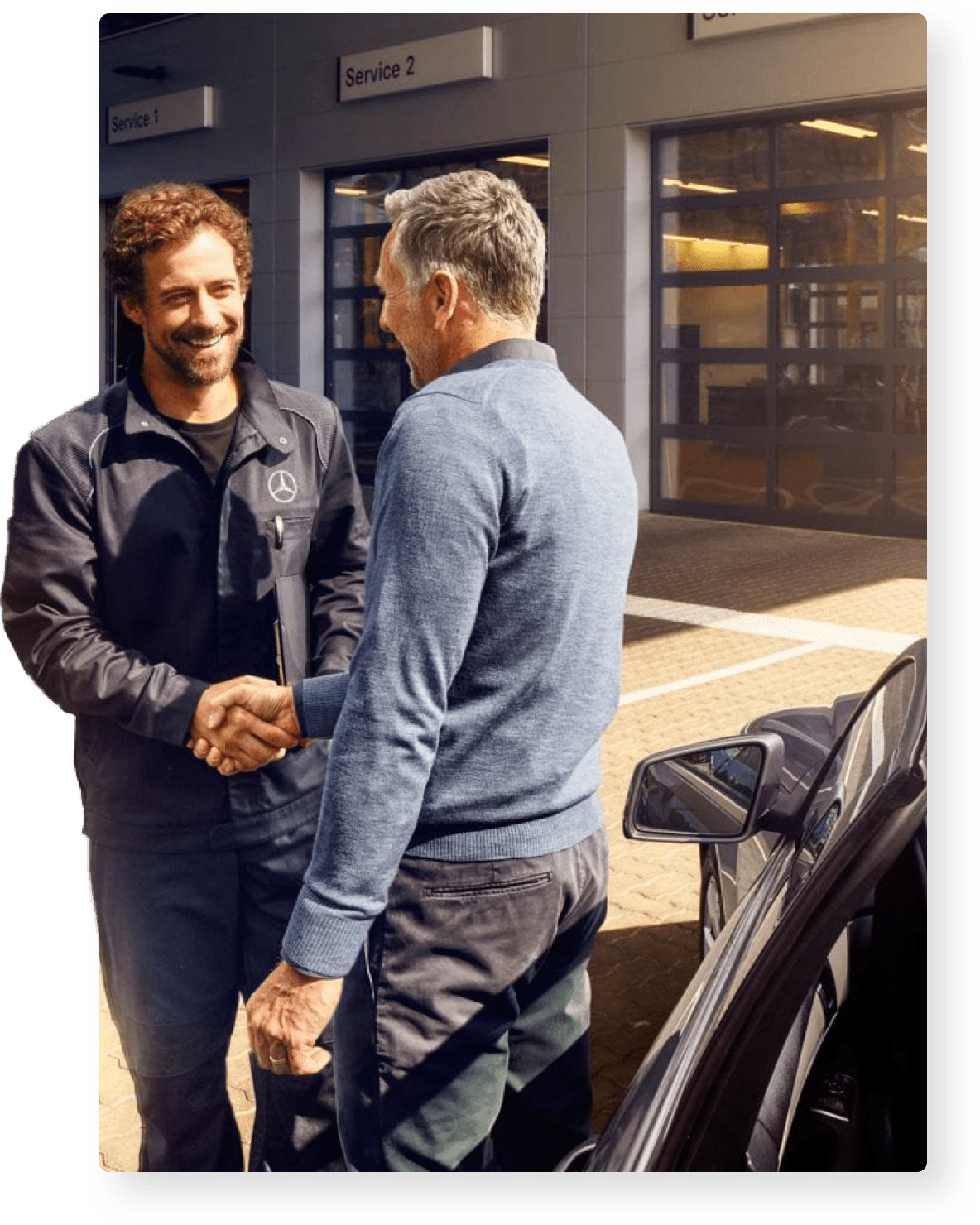Two people shaking hands in front of a showroom with a new car
